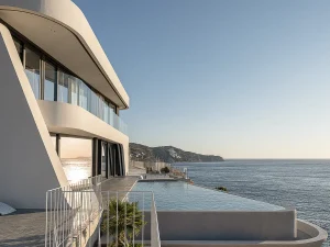 Architectural side view of villa with infinity pool merging into the Aegean horizon.