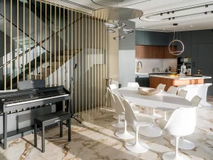 Open-plan luxury dining area inside Meltemi Villa with modern decor and sea view.